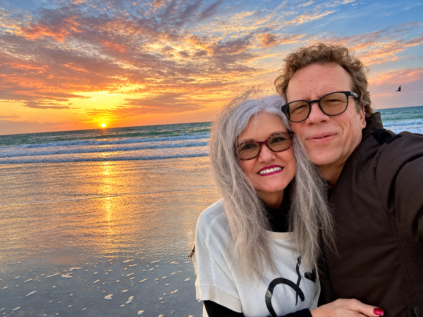 Carla Rae and John at the beach at sunset