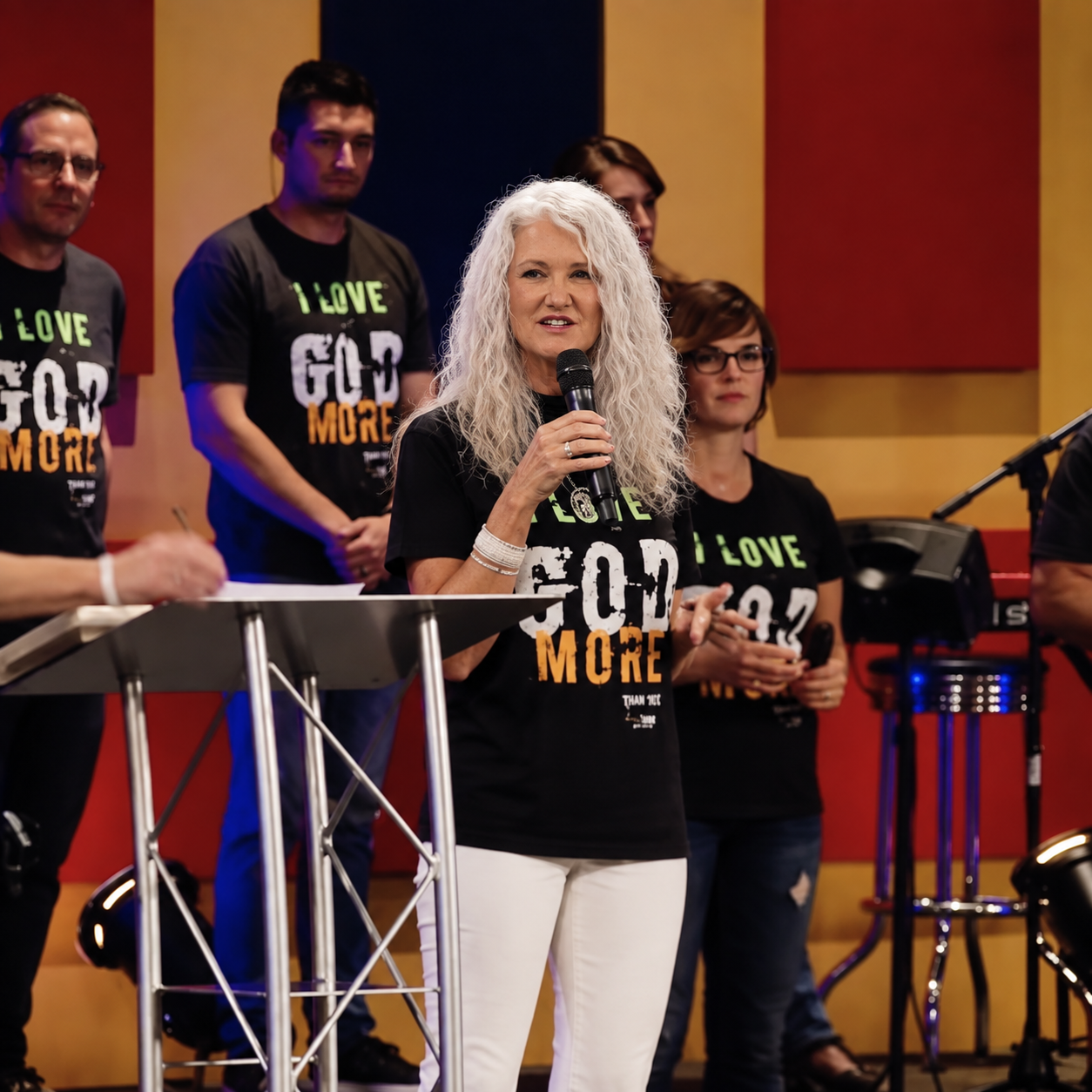 Carla Rae speaking with ministry team on stage